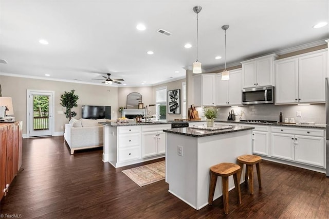 6605 Hedgerow Ct, Summerfield, NC 27358 - kitchen featuring stainless steel appliances, recessed lighting, a ceiling fan, a kitchen island, and a sink