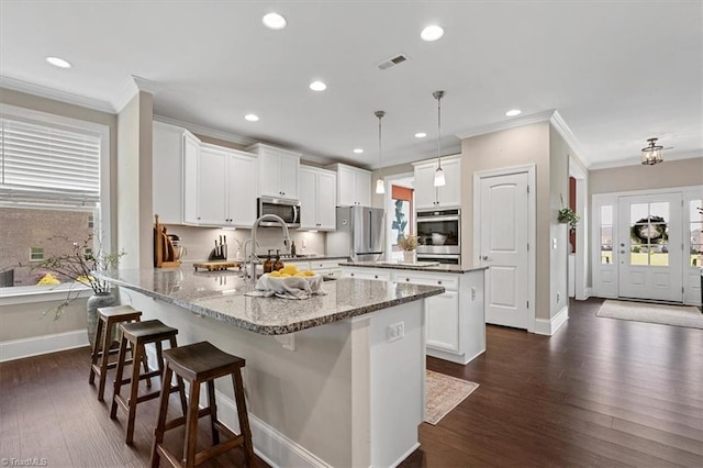 6605 Hedgerow Ct, Summerfield, NC 27358 - kitchen with ornamental molding, stainless steel appliances, baseboards, a peninsula, and recessed lighting