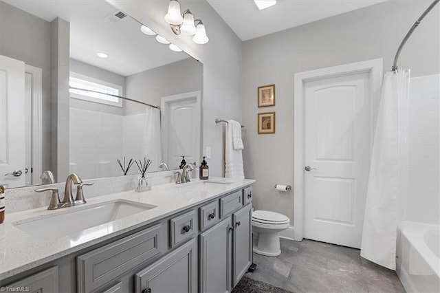 6605 Hedgerow Ct, Summerfield, NC 27358 - bathroom with double vanity, toilet, and shower / bath combo