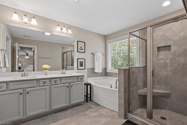 6605 Hedgerow Ct, Summerfield, NC 27358 - full bathroom featuring a bath, double vanity, a shower stall, and ceiling fan