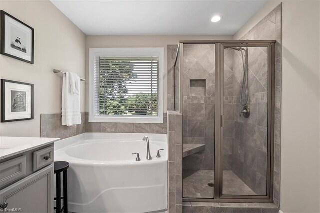 6605 Hedgerow Ct, Summerfield, NC 27358 - full bath with a garden tub, vanity, and a stall shower