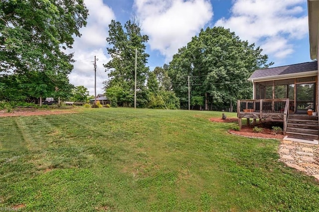 6605 Hedgerow Ct, Summerfield, NC 27358 - view of grassy yard featuring a wooden deck and a sunroom