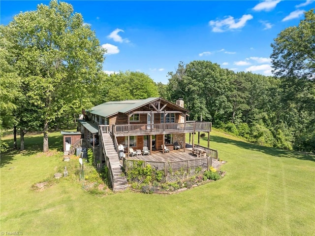 1215 Single Tree Rd, Westfield, NC 27016 - rear view of property featuring a deck, stairs, a lawn, a chimney, and a forest view