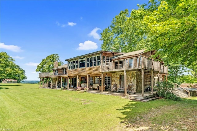 1215 Single Tree Rd, Westfield, NC 27016 - back of house with a yard, a deck, a chimney, and stone siding