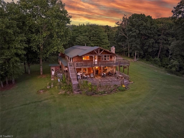 1215 Single Tree Rd, Westfield, NC 27016 - back of house with a chimney, a wooden deck, a yard, a view of trees, and stairs