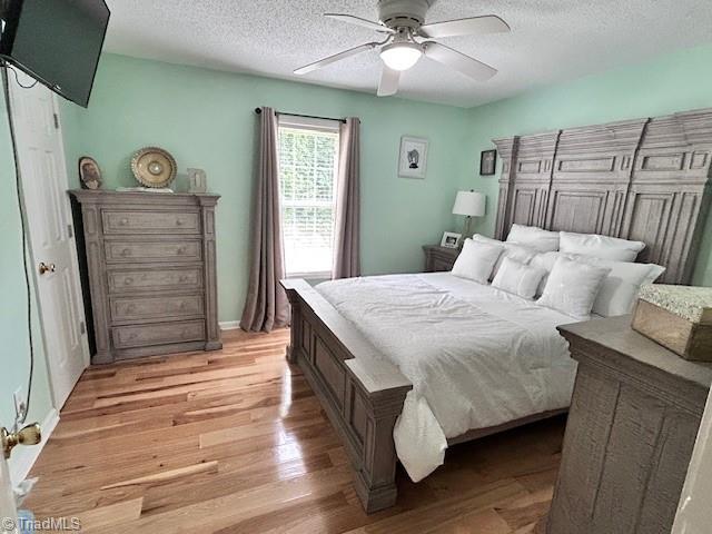 1320 Little Gate Dr, Asheboro, NC 27205 - bedroom with a textured ceiling, light wood-type flooring, and ceiling fan