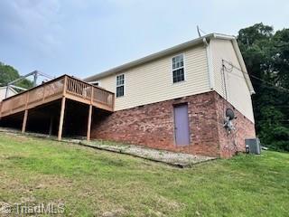 1320 Little Gate Dr, Asheboro, NC 27205 - back of house with a deck, a lawn, and brick siding
