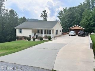 1320 Little Gate Dr, Asheboro, NC 27205 - ranch-style home with a front lawn, concrete driveway, and an outbuilding