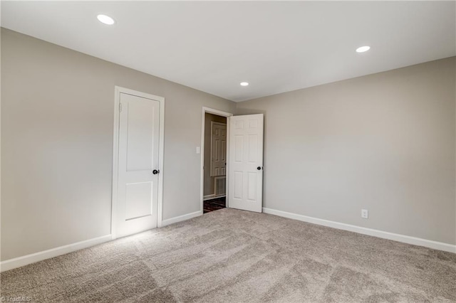 unfurnished bedroom with carpet, baseboards, and recessed lighting