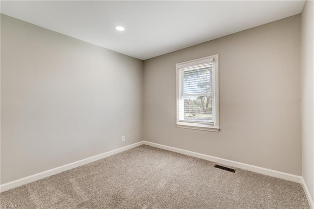 carpeted empty room with recessed lighting, visible vents, and baseboards