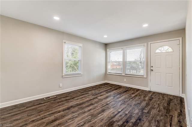 foyer entrance with dark wood-style floors, plenty of natural light, baseboards, and recessed lighting