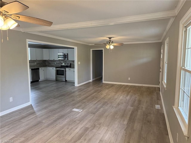 169 Pine View Rd, Eden, NC 27288 - unfurnished living room featuring wood finished floors, ceiling fan, baseboards, and ornamental molding