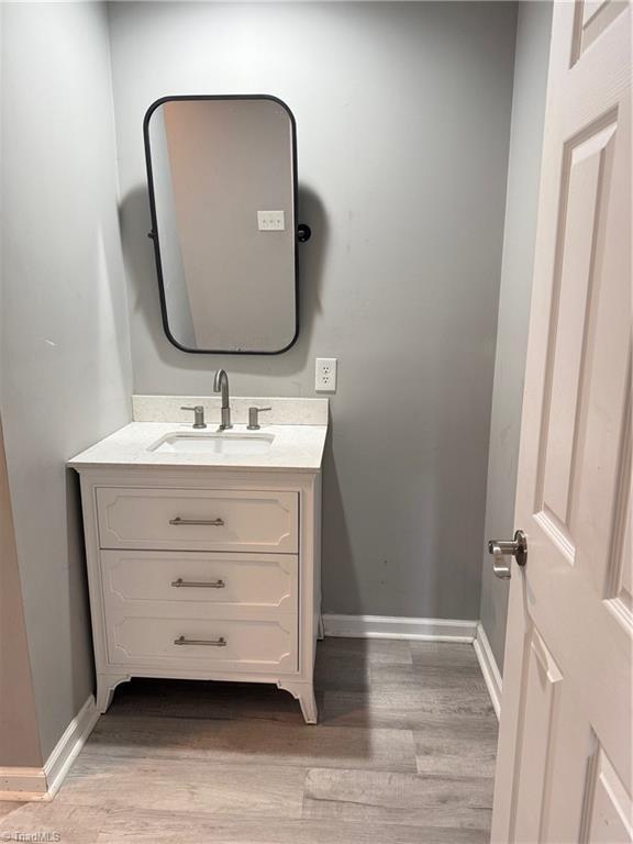169 Pine View Rd, Eden, NC 27288 - bathroom with vanity, baseboards, and wood finished floors
