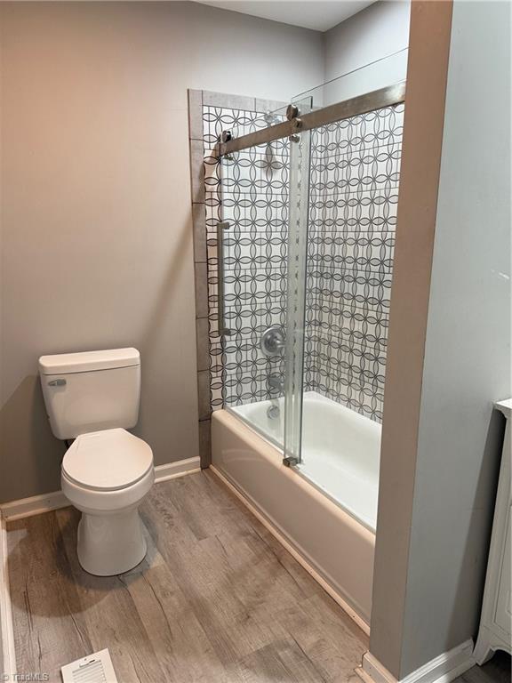 169 Pine View Rd, Eden, NC 27288 - bathroom featuring toilet, wood finished floors, baseboards, and visible vents
