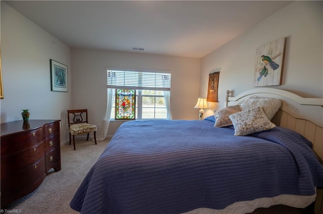 bedroom with carpet floors, baseboards, and visible vents