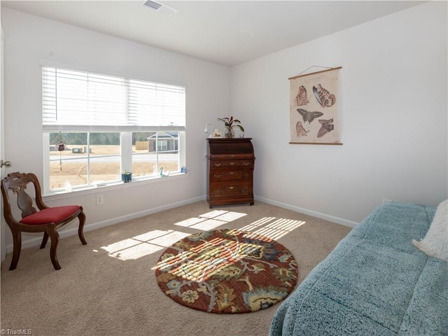 sitting room with baseboards, visible vents, and carpet flooring