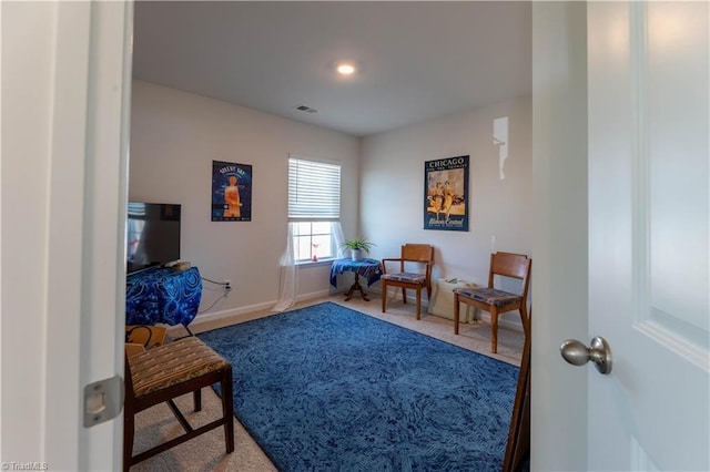 sitting room with baseboards, visible vents, and carpet flooring