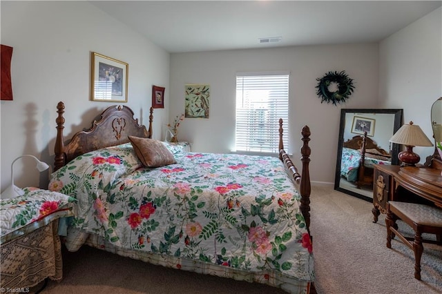 carpeted bedroom featuring visible vents