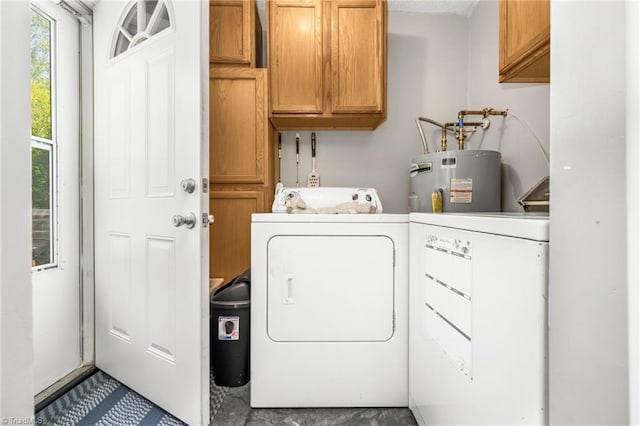 laundry room with independent washer and dryer, cabinet space, and electric water heater