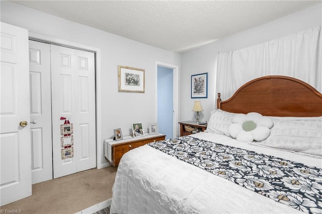 carpeted bedroom with a closet and a textured ceiling