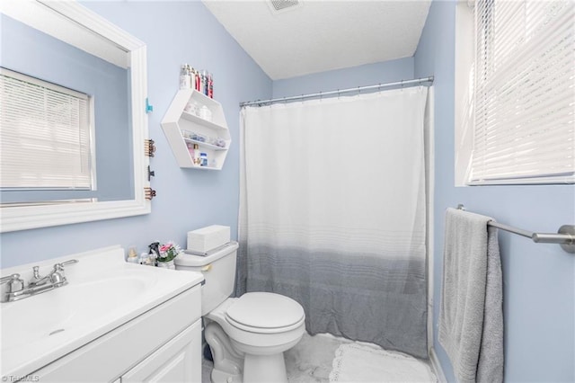 bathroom with toilet, visible vents, a wealth of natural light, and vanity