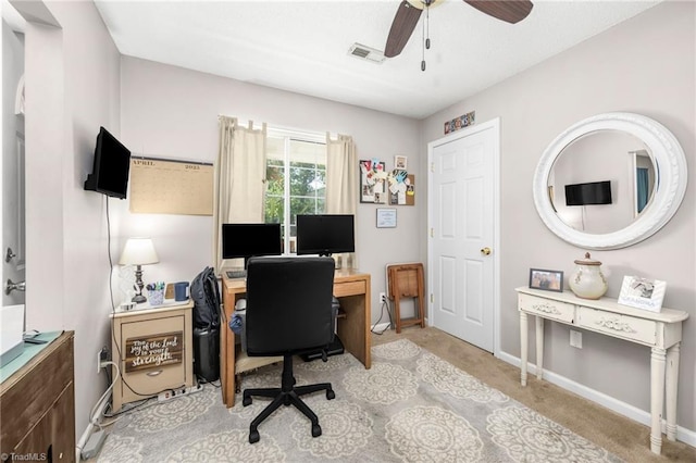 office with ceiling fan, visible vents, light carpet, and baseboards