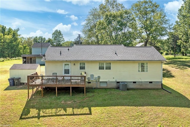 rear view of property featuring a deck, a storage unit, central AC unit, crawl space, and an outbuilding