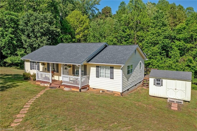 view of front facade featuring a storage shed, a porch, a front yard, crawl space, and an outbuilding
