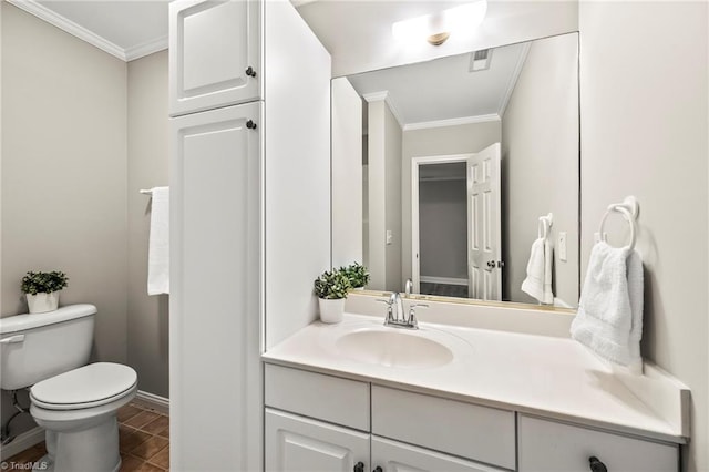 bathroom featuring tile patterned floors, ornamental molding, toilet, and vanity