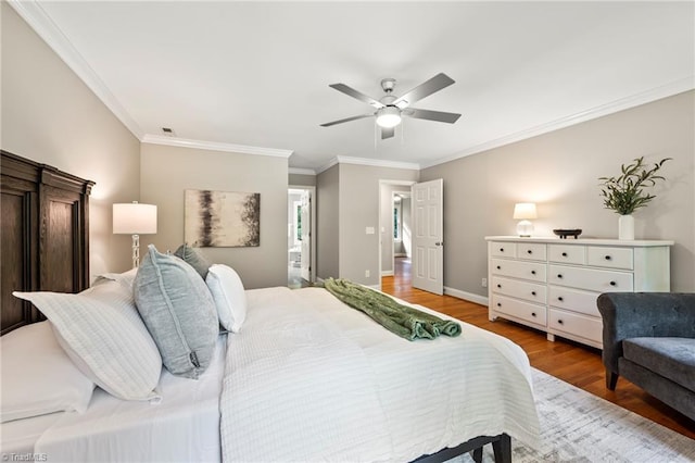 bedroom featuring wood-type flooring, ceiling fan, and crown molding