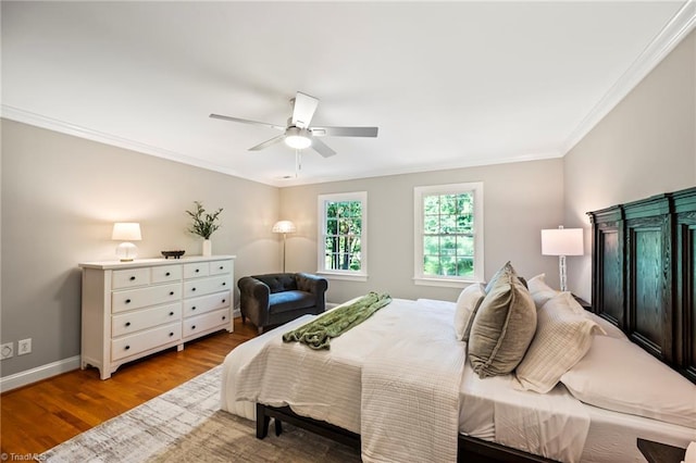 bedroom featuring crown molding, ceiling fan, and light hardwood / wood-style floors