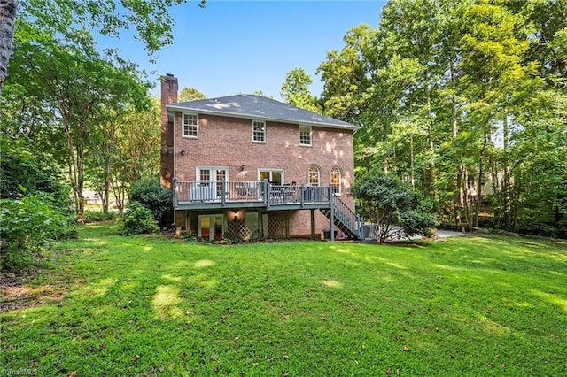 back of house featuring a yard and a deck