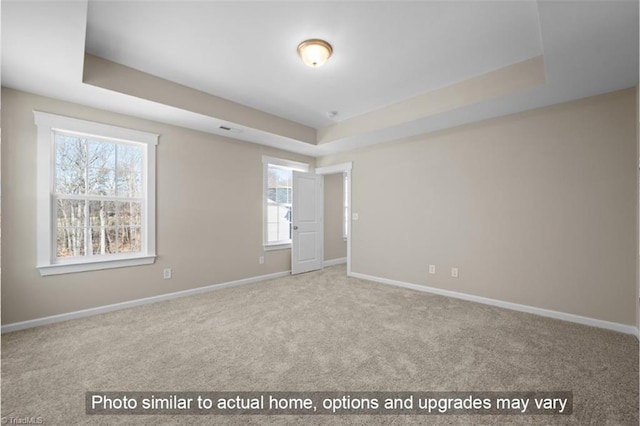 1425 Reading Ct Unit 78Kl, Burlington, NC 27217 - empty room featuring a raised ceiling, baseboards, and carpet floors
