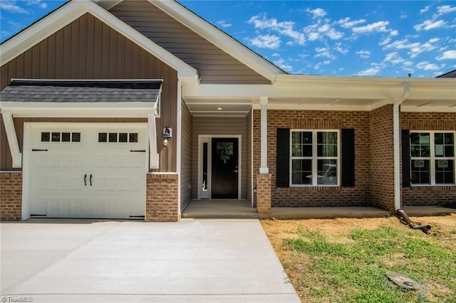 213 Cason Dr, Gibsonville, NC 27249 - view of front of home with brick siding, a porch, concrete driveway, and board and batten siding