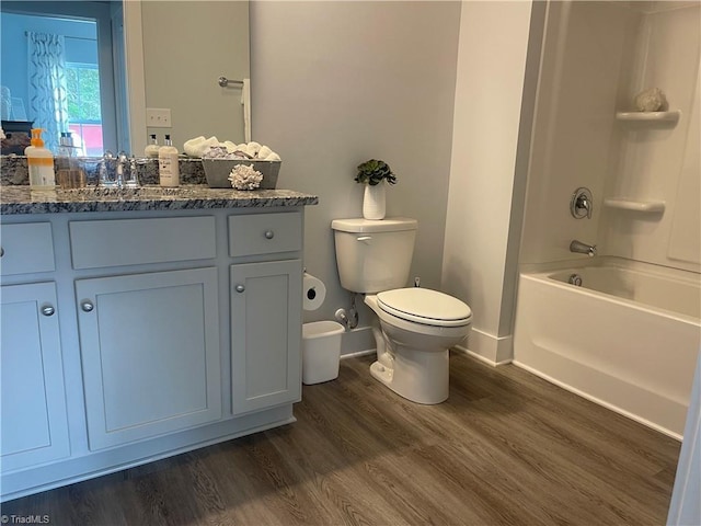 213 Cason Dr, Gibsonville, NC 27249 - bathroom featuring toilet, vanity, wood finished floors, tub / shower combination, and baseboards