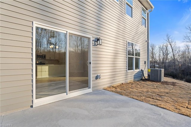 property entrance featuring central AC and a patio