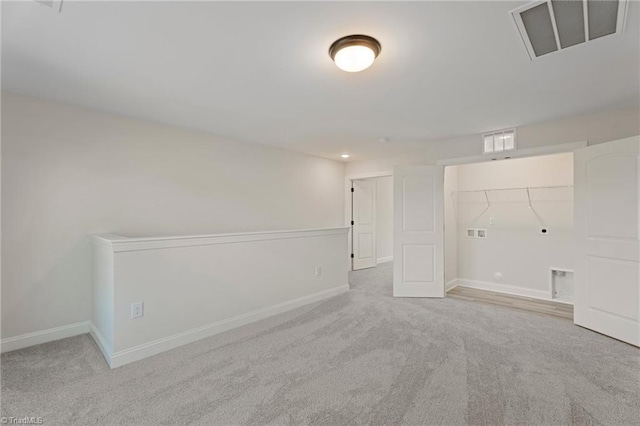 empty room with carpet, baseboards, and visible vents