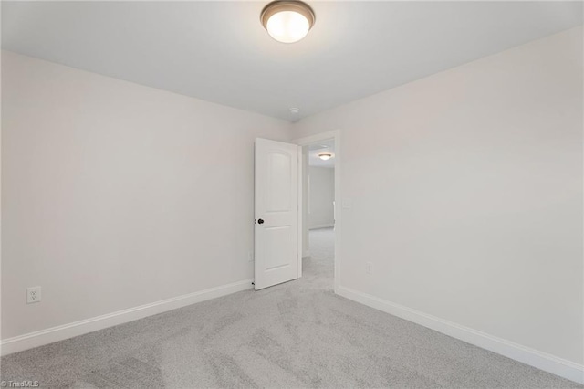 unfurnished room with carpet flooring and baseboards