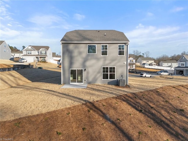 rear view of property featuring cooling unit and a patio area