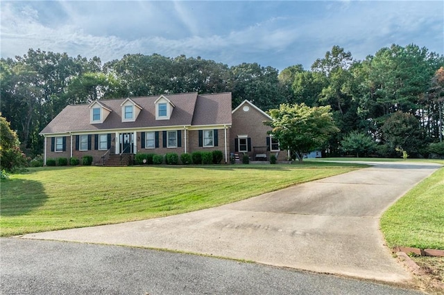 4905 Deer Pointe Ct, Greensboro, NC 27406 - cape cod home featuring brick siding, driveway, and a front lawn