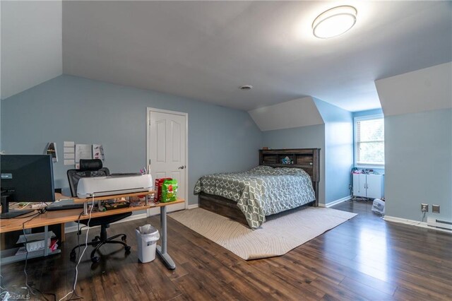 4905 Deer Pointe Ct, Greensboro, NC 27406 - bedroom featuring baseboards, lofted ceiling, a baseboard heating unit, and wood finished floors