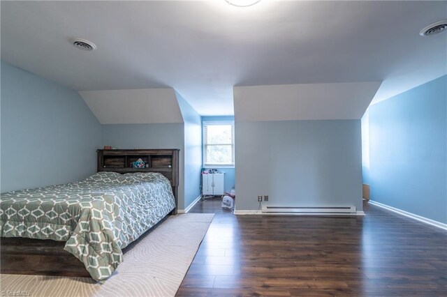 4905 Deer Pointe Ct, Greensboro, NC 27406 - bedroom featuring visible vents, vaulted ceiling, wood finished floors, and a baseboard radiator