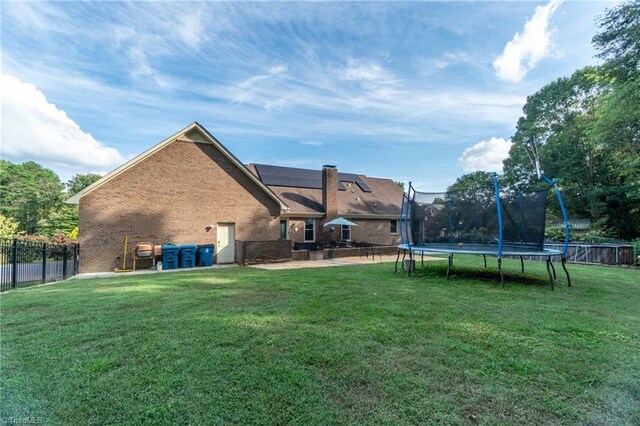 4905 Deer Pointe Ct, Greensboro, NC 27406 - view of yard with fence, a trampoline, and a patio area