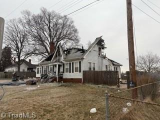 view of side of property featuring fence