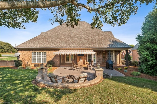 rear view of property featuring a patio and a lawn