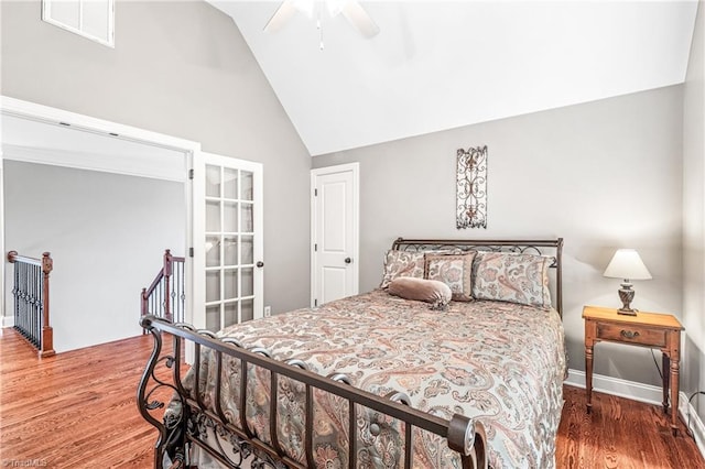 bedroom featuring wood-type flooring, high vaulted ceiling, and ceiling fan