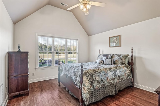 bedroom with dark hardwood / wood-style flooring, vaulted ceiling, and ceiling fan