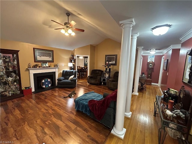 living room with ornate columns, ceiling fan, crown molding, wood-type flooring, and lofted ceiling