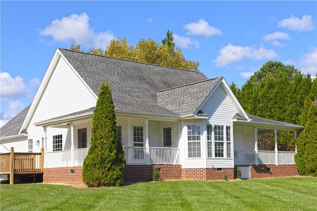 rear view of house featuring a porch and a yard