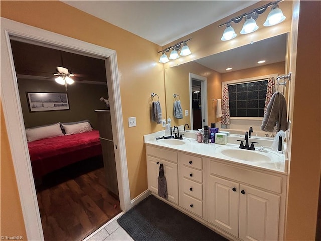 bathroom featuring a tub, ceiling fan, tile patterned flooring, and vanity